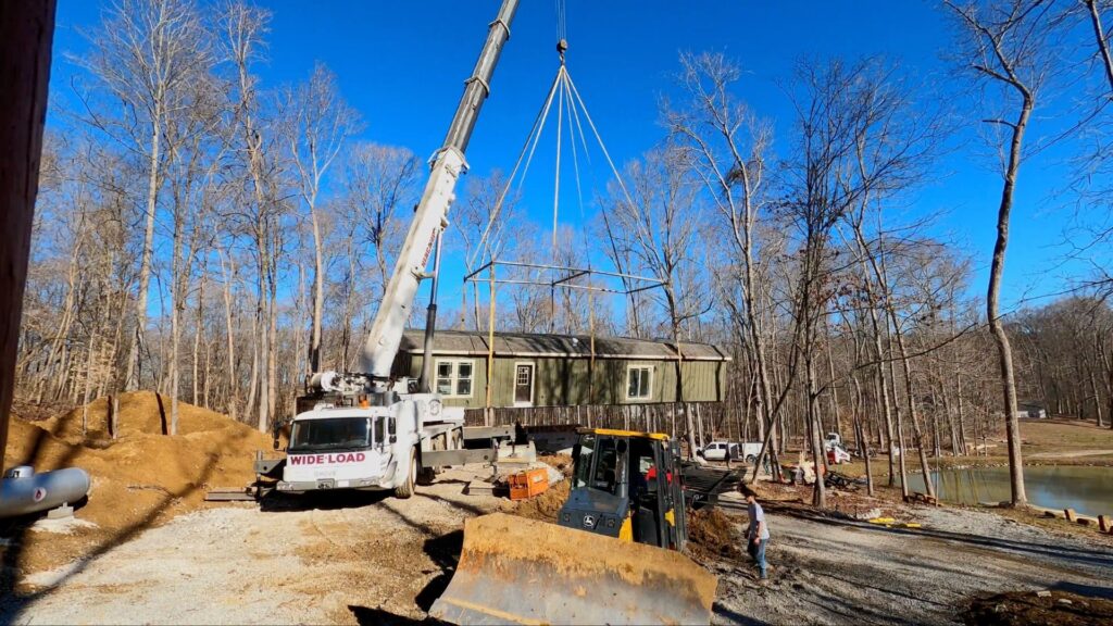 Manufactured home being placed on its foundation
